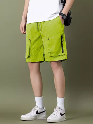 Green lightweight cargo shorts with zipper pockets and drawstring waist.