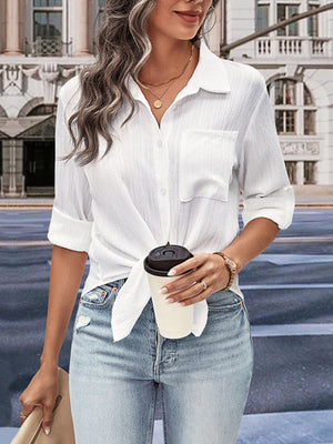 White textured tie-front collared shirt with chest pocket, rolled sleeves, and tie detail.