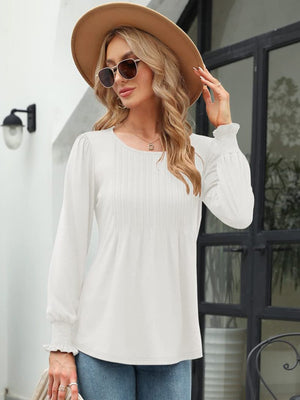 White long sleeve blouse with pleated bodice and gathered cuffs