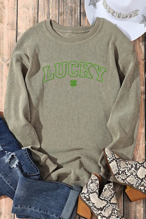 Light green ribbed crewneck sweatshirt with "LUCKY" graphic and shamrock detail.