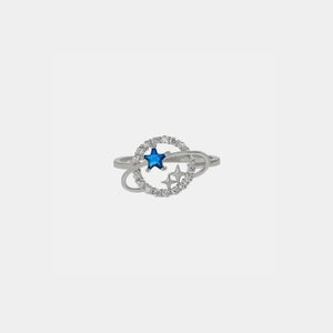 Silver ring with celestial orbit design, blue zircon star, and clear stones