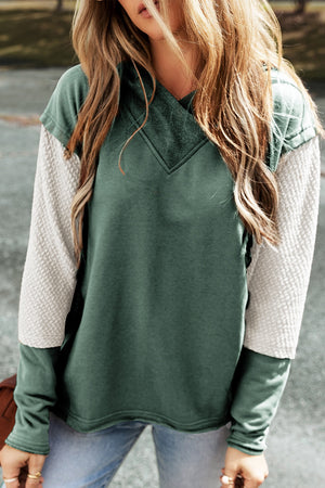 Sage green hoodie with textured cream sleeves and V-neck detail