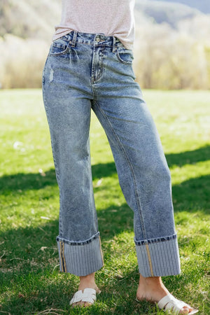 Cuffed mid-rise relaxed fit denim jeans with distressed details and striped cuffs.