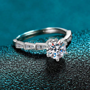Sterling silver ring with brilliant moissanite and accent stones, adjustable band.