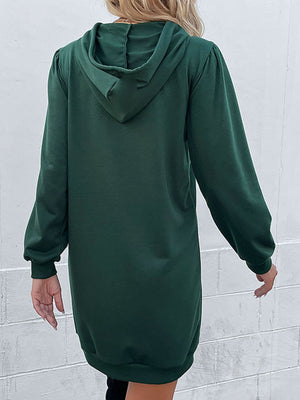 Green hooded mini dress with sculpted shoulders and long sleeves