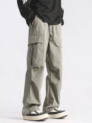 Plus-size loose fit cargo pants in green with drawstring waist and zippered pockets.