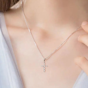 Silver diamond-set cross pendant necklace with a delicate chain.