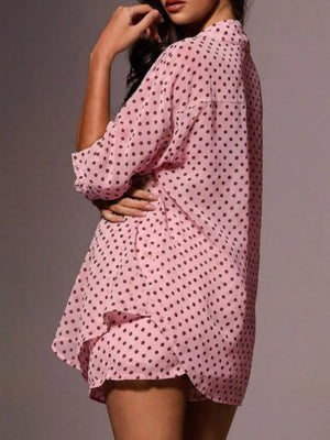 Pink polka dot sheer two-piece set with a collared shirt and ruffled hem shorts.