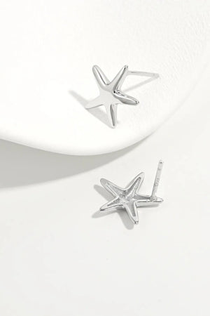 Sculpted starfish stud earrings in silver, featuring a detailed starfish design.