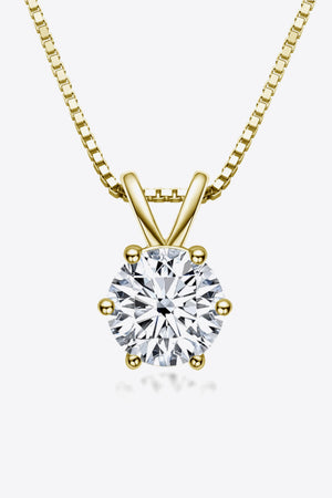 Gold moissanite pendant necklace with 1 carat round brilliant cut stone on a box chain.