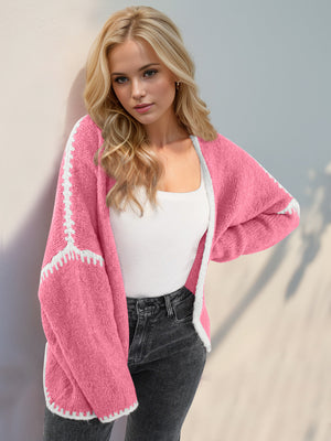 Pink oversized knit cardigan with contrast white stitching and trim