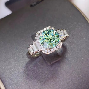Emerald halo ring with baguette side stones in silver.