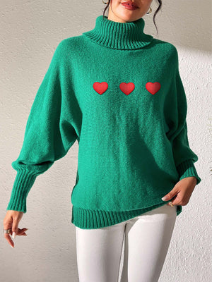 Green turtleneck sweater with balloon sleeves and red heart appliqué detail
