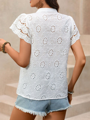 White eyelet embroidered button-up maternity overshirt with short sleeves and a collared neckline.