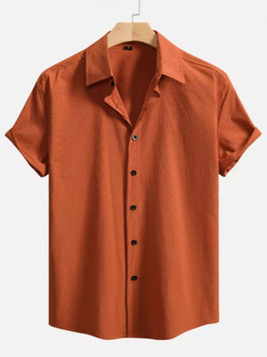 Orange textured Cuban collar casual shirt with short sleeves and button-down front.