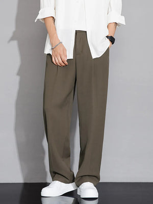 Men's brown wide-leg chinos with a relaxed fit, styled with a white shirt.