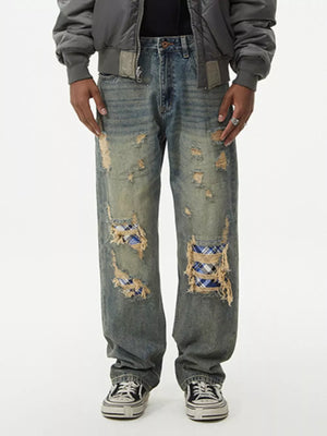 Distressed denim wide leg jeans with plaid patches and frayed details.