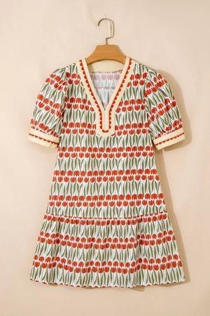 Cotton mini dress with red tulip print, V-neck, puff sleeves, and tiered skirt.