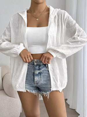White crinkled lightweight hooded jacket with zip closure and elastic cuffs.
