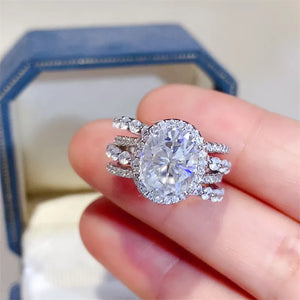 Silver triple band oval moissanite halo ring with sparkling accents
