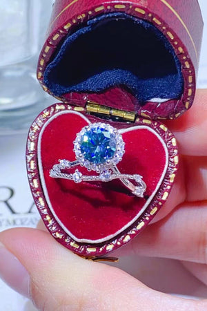 Sky blue moissanite halo engagement ring set with diamond band in red heart box