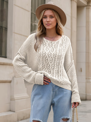 Cable knit cocoon sweater in white with a relaxed fit and crew neck.
