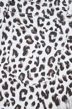 Leopard print denim shorts with frayed hem detail.