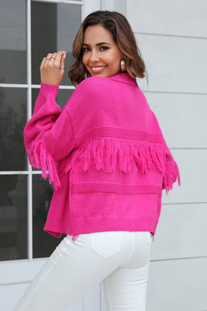 Hot Pink acrylic cardigan with fringe detail on sleeves and hem.