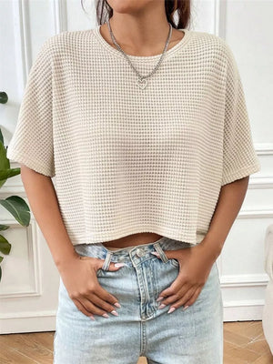 Apricot waffle-knit cropped t-shirt with crew neck and short sleeves.