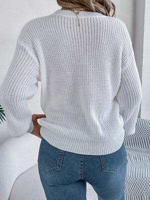 White acrylic knit sweater with a relaxed fit and ribbed details.