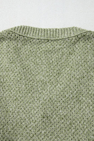 Matcha green open-knit slouchy V-neck sweater with ribbed neckline detail.