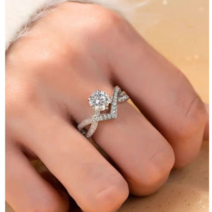 Moissanite sterling silver crossover ring with pave diamond band and solitaire stone.