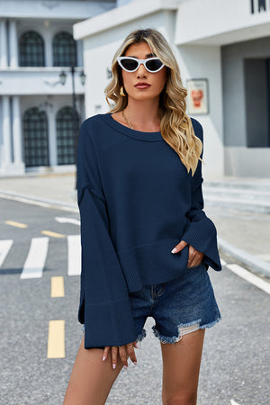 Peacock blue acrylic sweater with flared sleeves and split hem