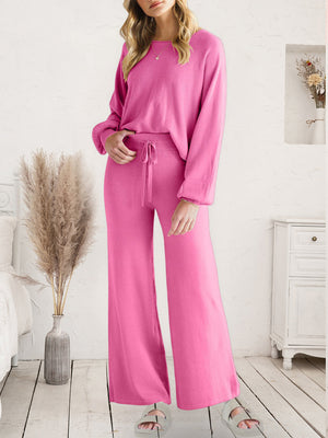 Pink acrylic loungewear set with wide-leg pants and long sleeves.