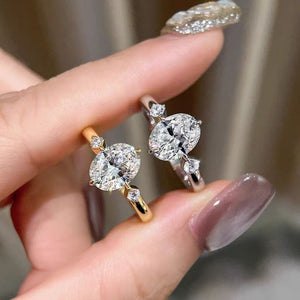 Moissanite sterling rings with oval center stones and accent stones in gold and silver.