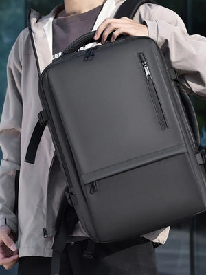 Dark gray convertible commuter backpack with multiple zippered pockets and padded straps.