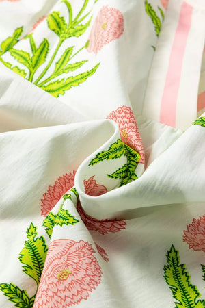 Cotton blouse with vibrant pink floral print and ruffled sleeve detail.