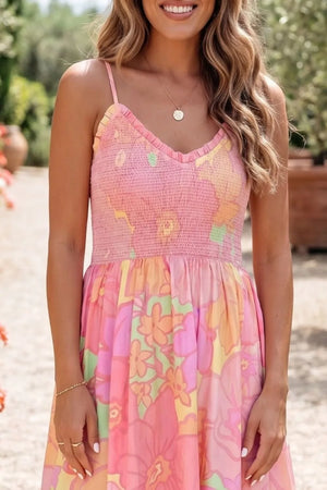 Smocked floral print cotton dress with ruffled neckline and spaghetti straps.