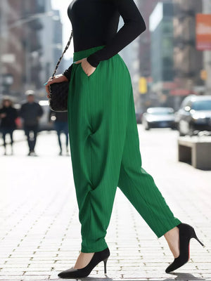 Plus size green ribbed casual pants with pockets, styled with black heels.