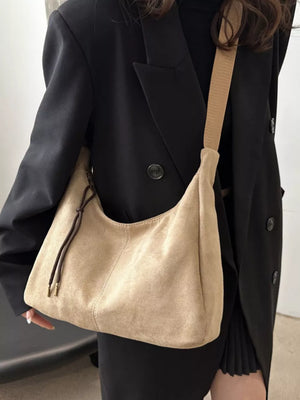 Khaki suede crossbody bag with adjustable strap and drawstring detail