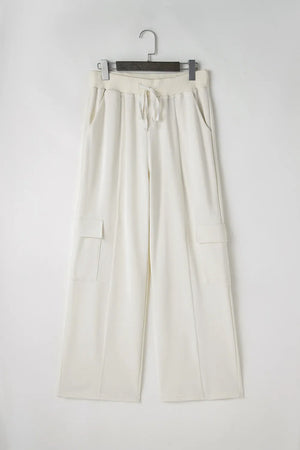 Ivory wide leg cargo pants with drawstring waist and side cargo pockets.