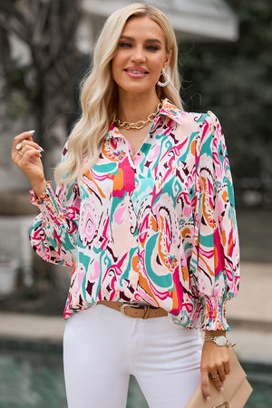Women's abstract print blouse with gathered cuffs in hot pink and pastel blue.