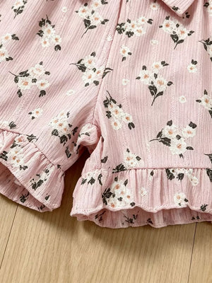 Pink floral ruffle baby romper with a bow detail