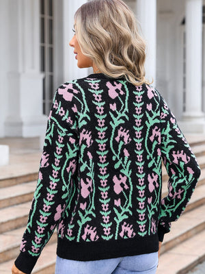 Black crewneck sweater with pink and green floral tapestry pattern, acrylic knit.