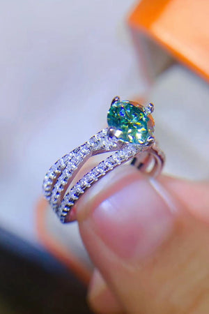 Twisted pavé halo ring with light green stone and sterling silver band.