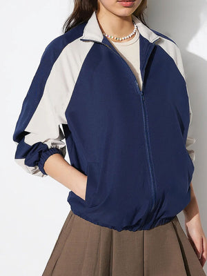 Colorblock raglan sleeve bomber jacket in dark blue and light grey with elastic cuffs and hem.
