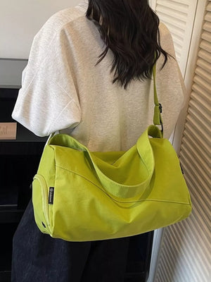 Casual large green Oxford cloth travel bag with adjustable strap and side zip pocket.