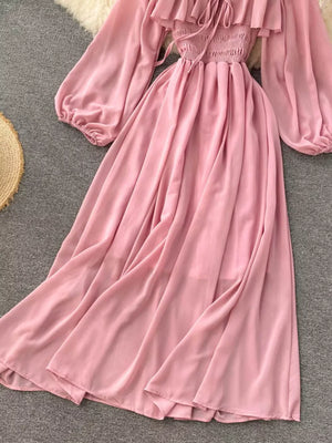 Pink maternity dress with ruffled square neck, smocked bodice, balloon sleeves, and A-line skirt.
