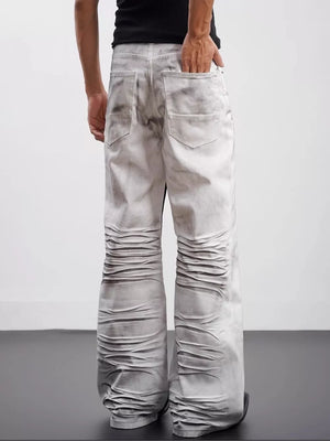 Men's wide-leg jeans in black and white with ruched detailing and contrast wash.