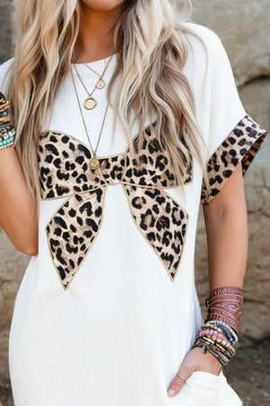 White midi dress with leopard print bow detail and sleeve trim.